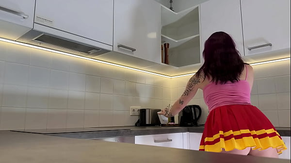 Hottest redhead tattooed cheerleader with over knee socks shows her see through panties in the kitchen