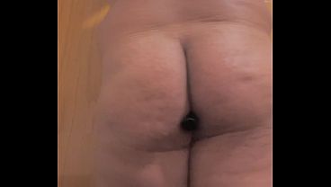 A gay man inserts a sex toy into his ass.
